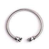 Bracelet jonc boxe finition argent, câble d'acier torsadé et embouts poings fermés