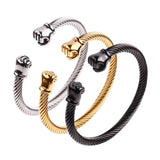 Bracelet jonc boxe en câble d'acier torsadé, embouts poings fermés : les trois finitions or, argent et noir