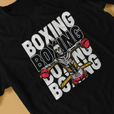 Détail du t-shirt boxe squelette, ceinture de champion et cordes de ring jaunes