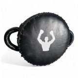 Mini bouclier de frappe rond 25 cm Esprit Boxe en cuir véritable noir, face de frappe avec logo blanc, laçage cuir apparent et poignées renforcées