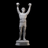 Figurine Rocky Balboa à peindre, résine grise, bras levés avec ceinture de champion