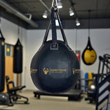 Sac de frappe rond Esprit Boxe suspendu en salle de boxe