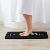 Paillasson boxe noir et blanc sous les pieds nus, surface douce