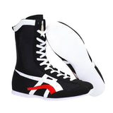 Botte de boxe noire et sa semelle blanche, vue de profil