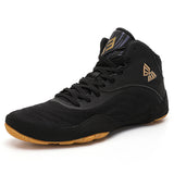 Chaussure de boxe noir et or vue de trois quarts, tige mesh