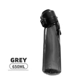 Gourde boxe aromatisée grise 650 ml, bec ouvert et dosettes de saveur