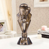Trophée boxe constitué d'un gant de boxe sur une statue étoilée, finition bronze