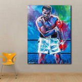 Tableau Mohamed Ali dans le ring, bras croises, gants rouges, fond bleu et vert, affiche dans un salon