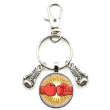 Porte-clés boxe cabochon verre, motif gants de boxe rouges sur éclat jaune