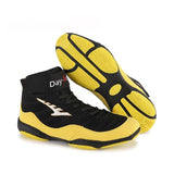 Chaussures de boxe basses jaune et noir, paire et semelle à pastilles jaunes